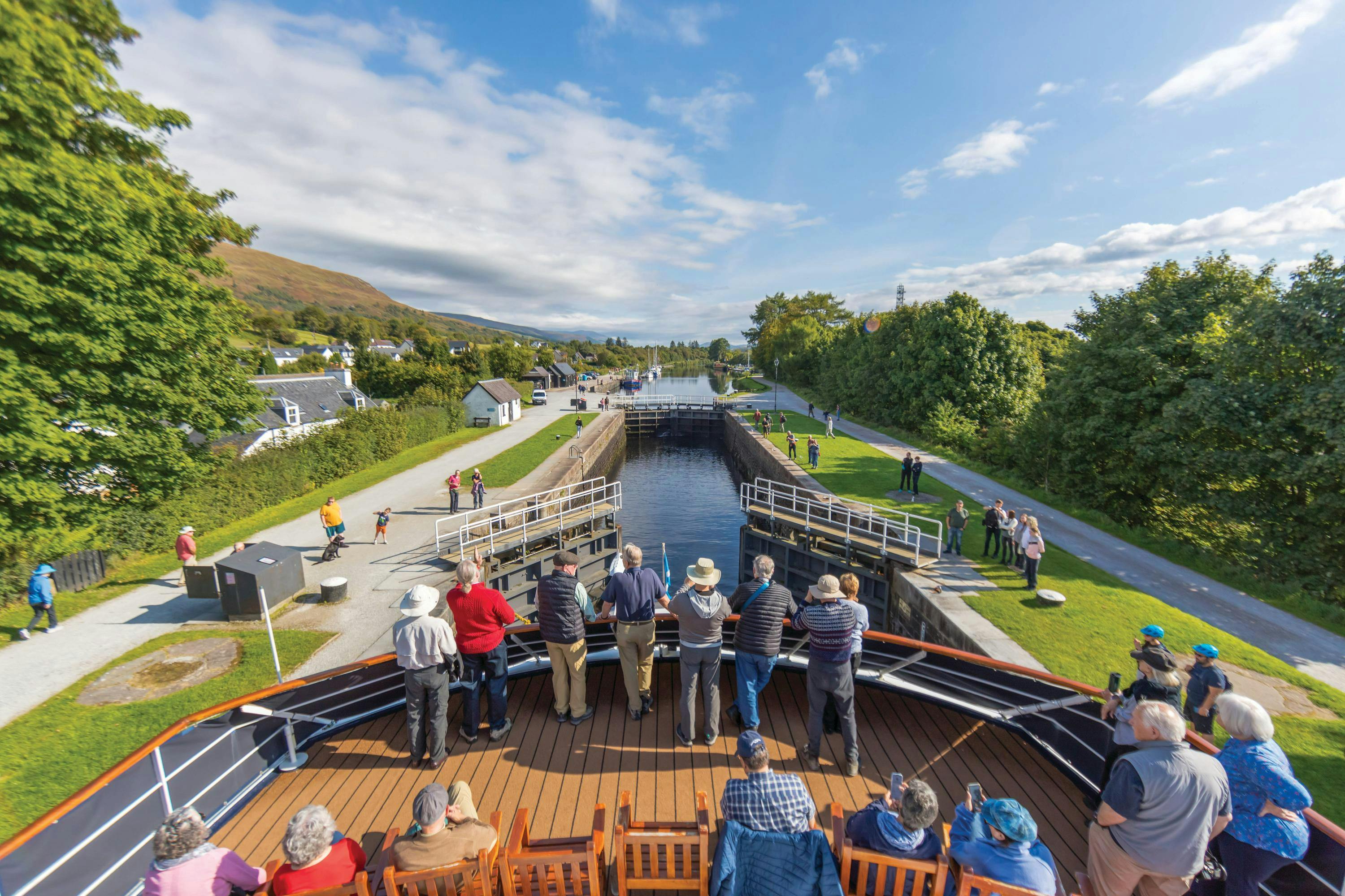 Guests watch on as Lord of the Glens transits the lock system on the Caledonian Canal, Scotland.