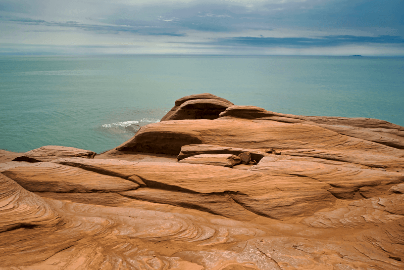 Canada, Quebec, Iles-de-la-Madeleine. Red cliffs and ocean