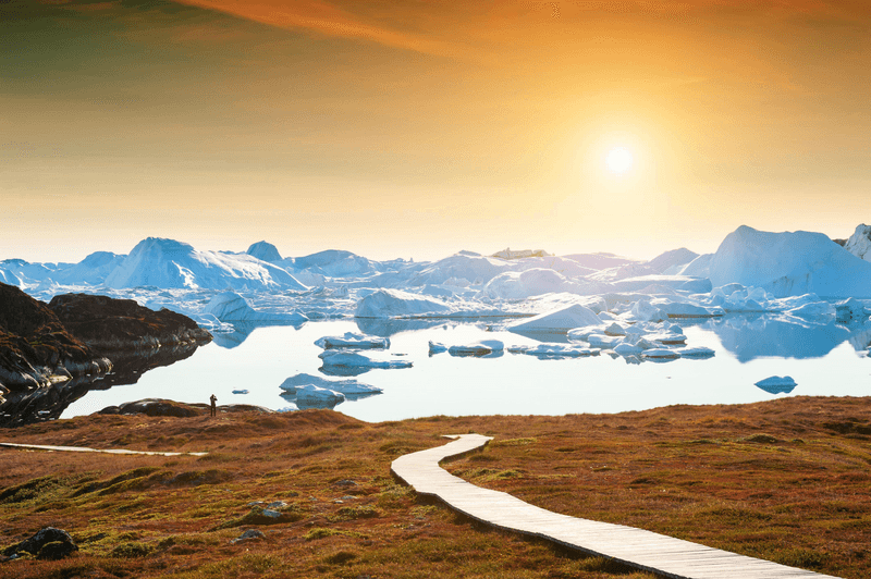 Hiking trail to the ice fjord in Ilulissat at sunset, western Greenland. Summer landscape