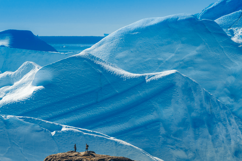 Hikers on a iceberg overlook boardwalk trail, Ilulissat Icefjord, Disko Bay, Greenland