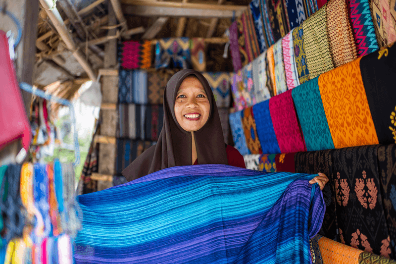 Vendors narrow passages amongst the thatched houses in Lombok, Sade, Sasak Village, West Nusa Tenggara, Indonesia