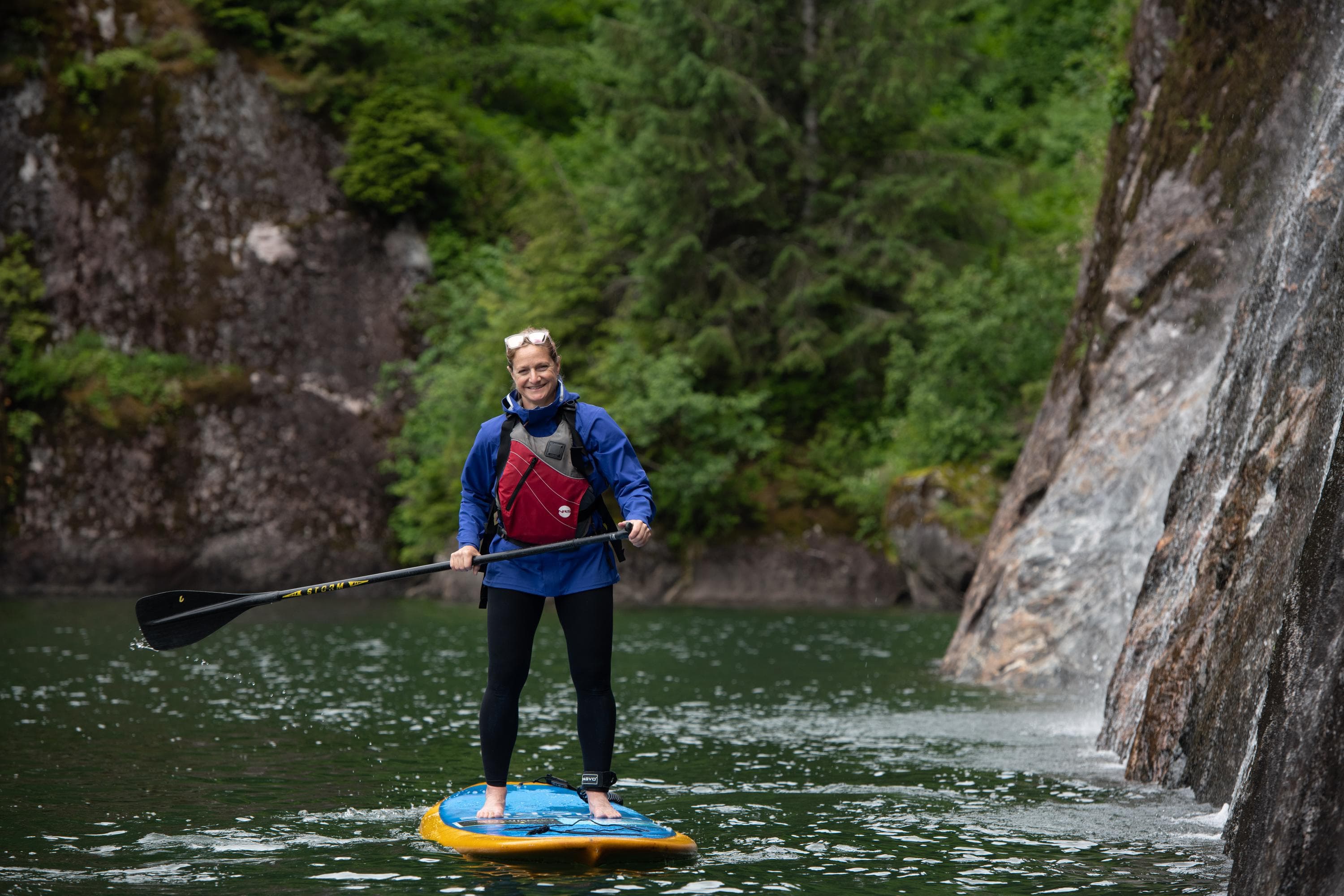 Guests explore by Standup Paddleboard, Owl Pass in Rudyerd Bay, Misty Fiords National Monument, Ketchikan, Alaska, USA.