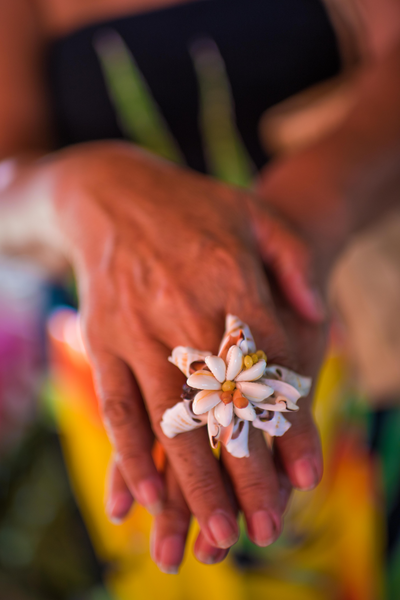 A local artisan shows off shell flower jewelry in Huahine