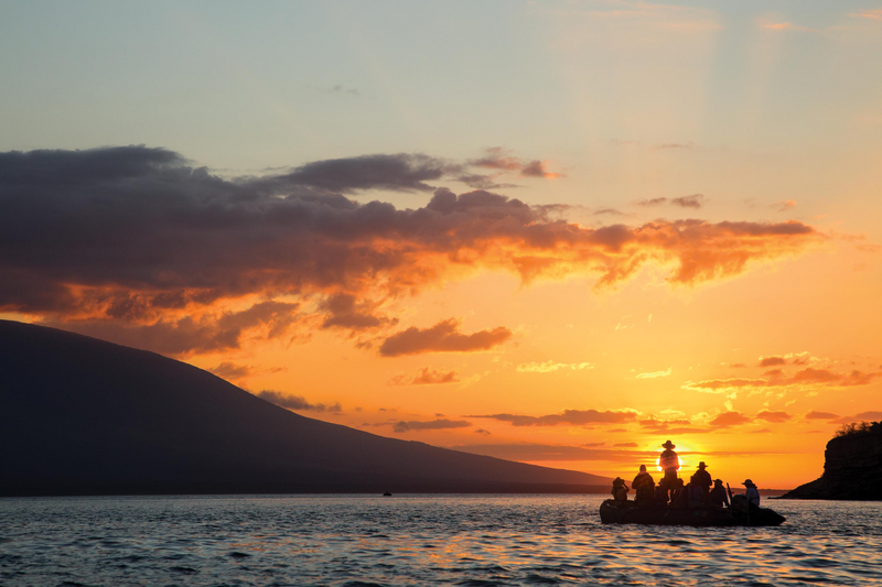 Guests explore at sunset by zodiac in Galapagos, Ecuador