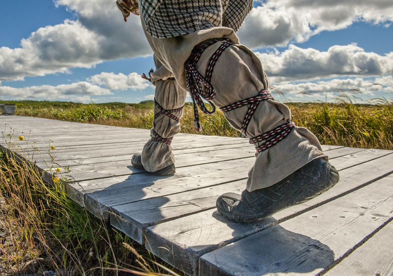 A person walking the L'Anse aux Meadows, an archaaeological site in Newfoundland, Canadian, Arctic