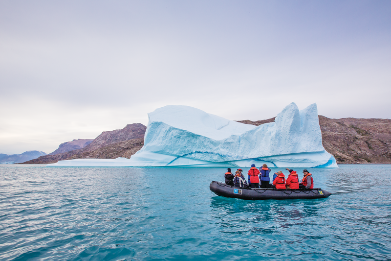 Guests explore by zaodiac from the ship National Geographic Explorer amongst grounded icebergs in Sydkap, Northeast Greenland