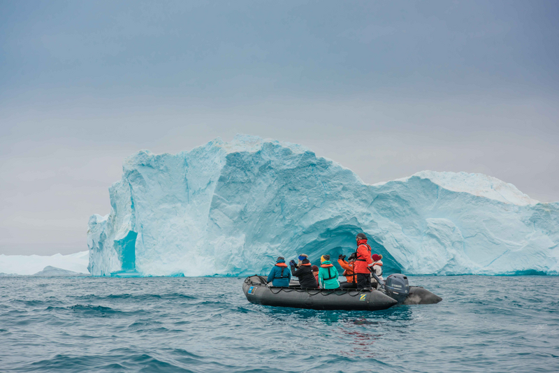 Guests explore the towering Icebergs Ilulissat Icefjord, Greenland.