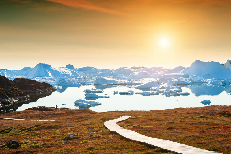 Hiking trail to the ice fjord in Ilulissat at sunset, western Greenland. Summer landscape