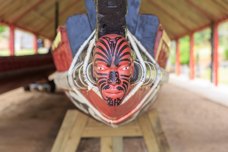 A typical maori puppet head with moko at the end of a war canoe in Waitangi, New Zealand.
