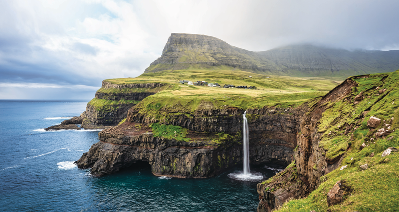 View of the iconic natural Mulafossur - Múlafossur Waterfall and Gasadalur village on Vágar Island, Faroe Islands, Denmark, Europe -- TESTING
