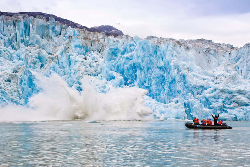 Guests explore on Zodiac in Southeast Alaska, Tracy Arm, calving ice. South Sawyer Glacier in Tracy Arm - Fords Terror Wilderness area in Southeast Alaska, USA