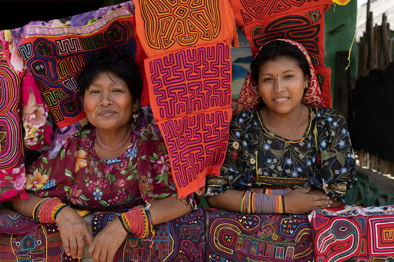 Two Guna women, one of the very first indigenous groups to achieve autonomy in Latin America, sell their textiles at a local market in Guna Yala, Panama