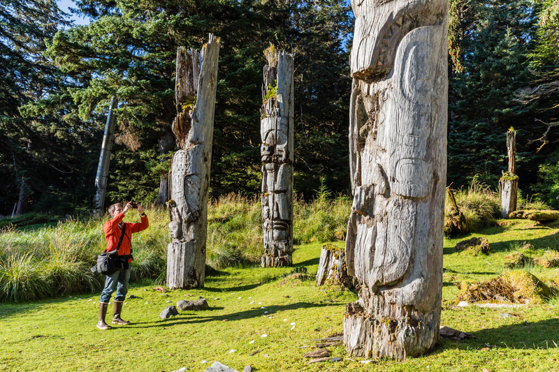 A guest photographs the totems of Haida Gwaii at SGang Gwaay, Anthony Island, British Columbia, Canada