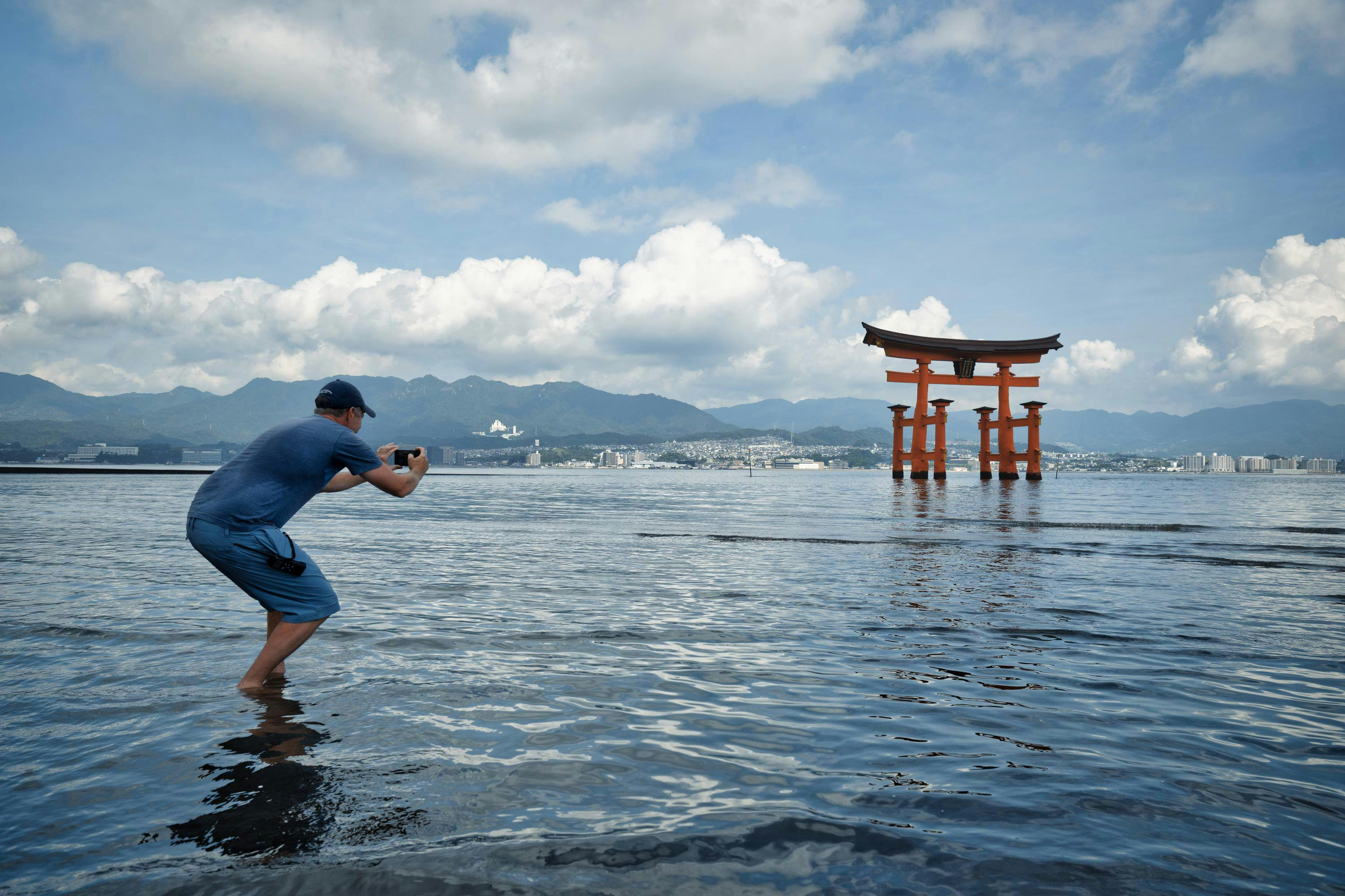 Itsukushima, or Miyajima, a serene island in Hiroshima Bay, Japan. Home to ancient temples and a famous partially submerged orange Great Torii Gate at high tide, marking the entrance to the 12th-century Itsukushima Shrine.