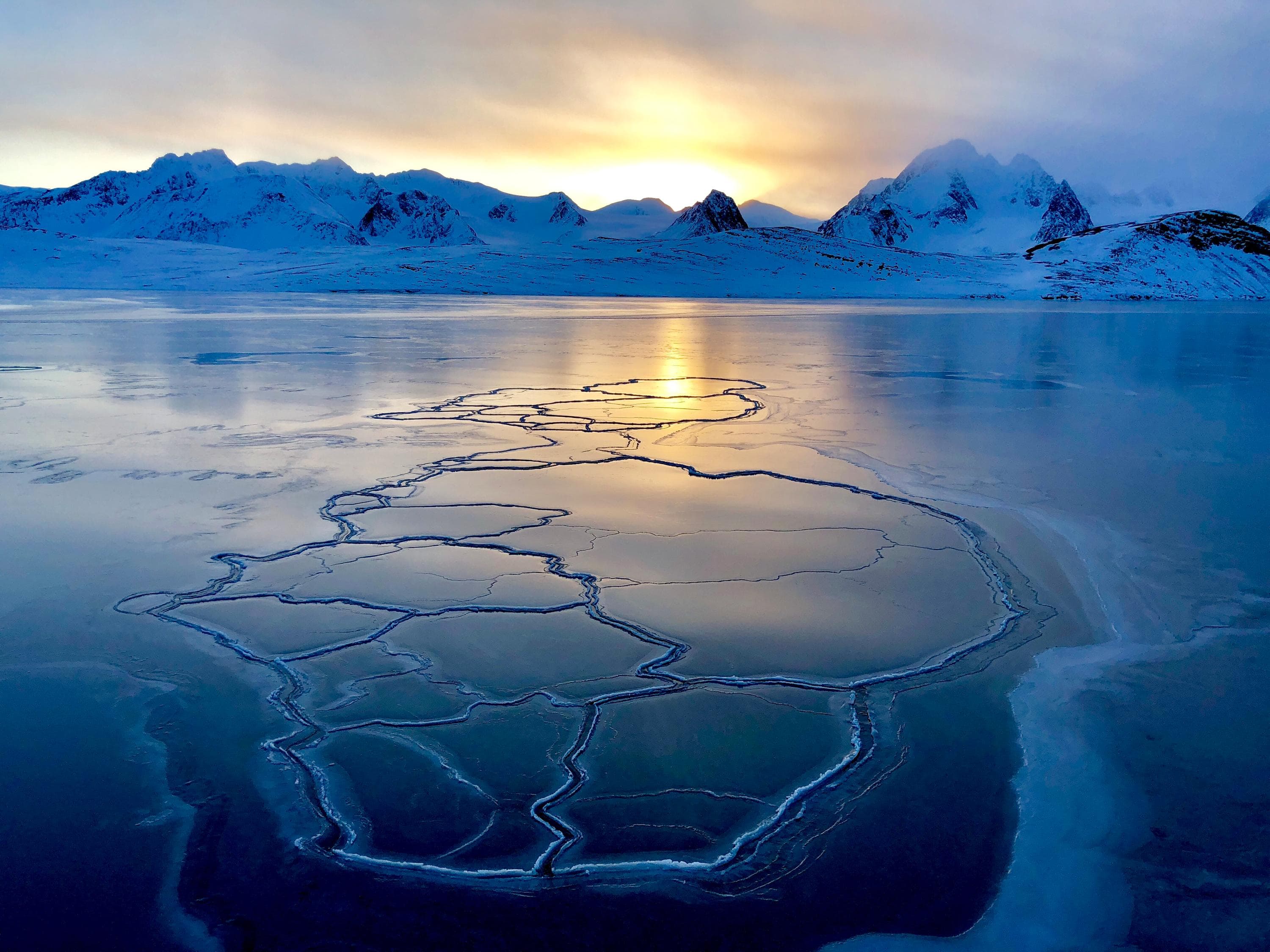 A sunrise view of the ice and mountains during the Reconnaissance voyage to the high Arctic