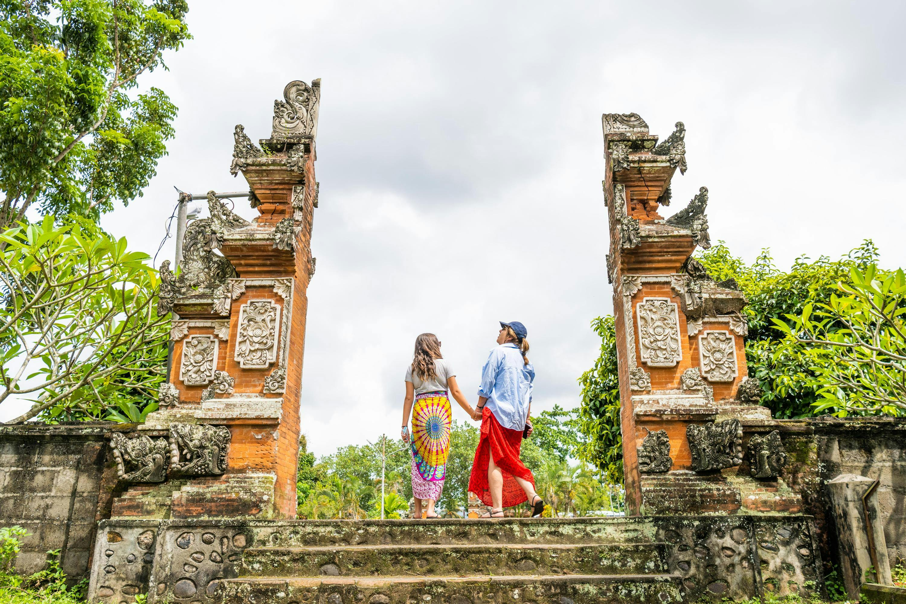 Guests explore Lingsar Temple a place where Hindus, Muslims, and Buddhists worship. Lombok, West Nusa Tenggara, Indonesia