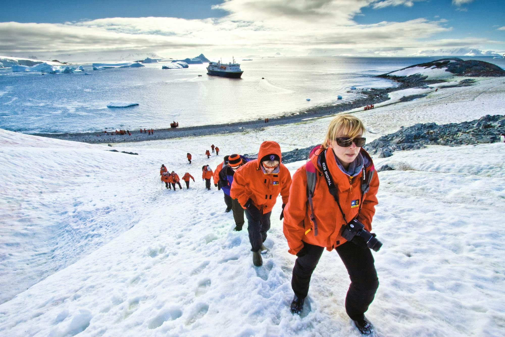 Guests from the ship National Geographic Explorer enjoy Cuverville Island, Antarctica.