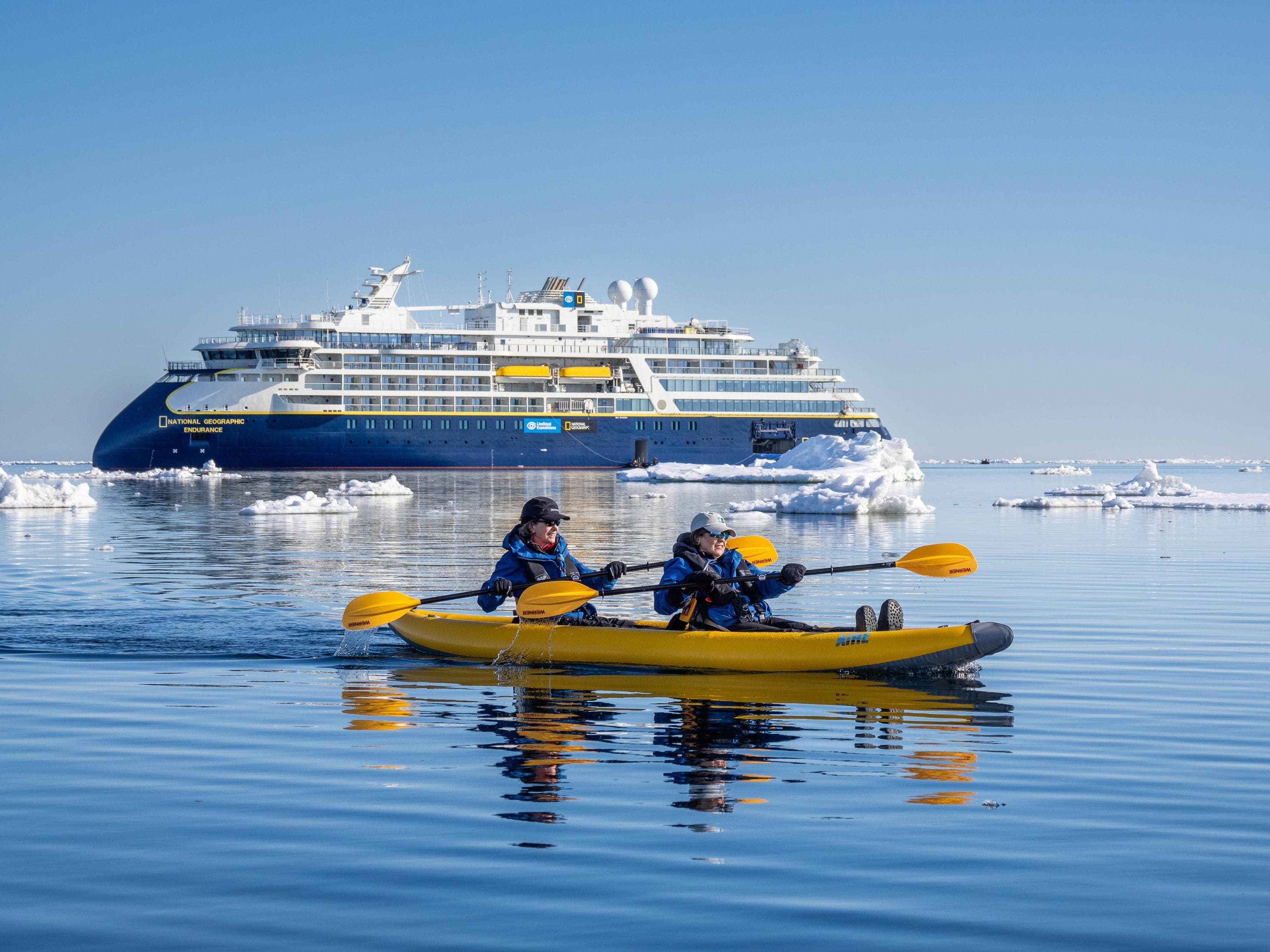 Guests from the National Geographic Endurance kayaking in ice off the island of Edge Island, Svalbard, Norway..