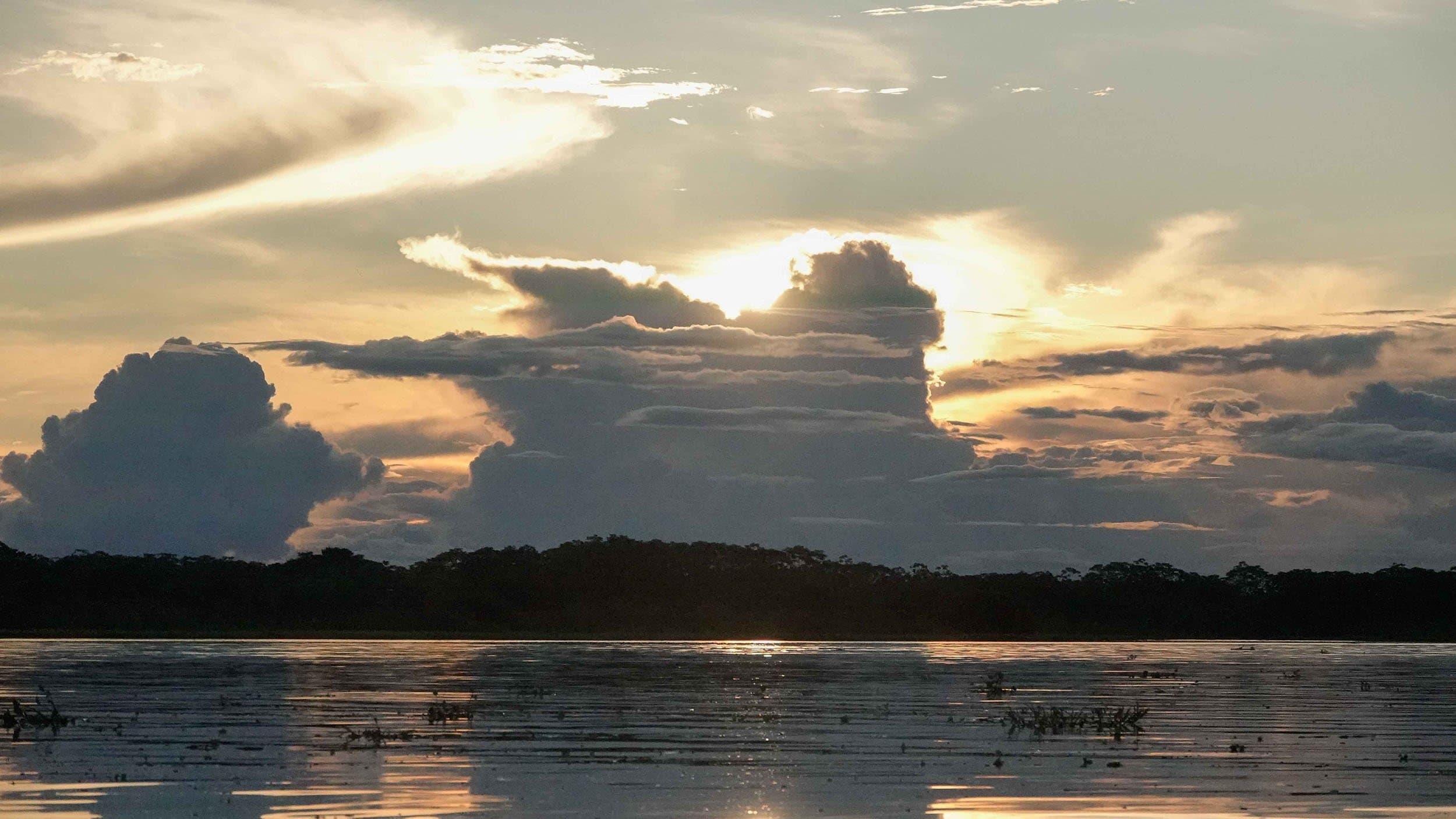 sunset over the amazon river