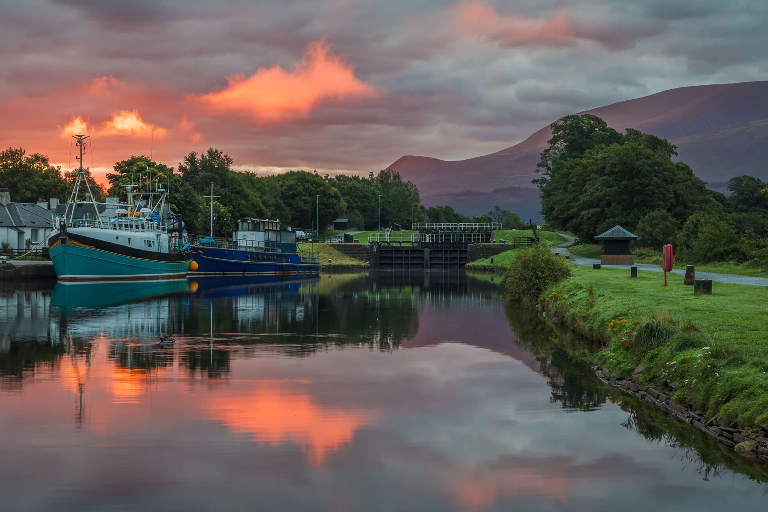 sunrise over a dock filled with small boats