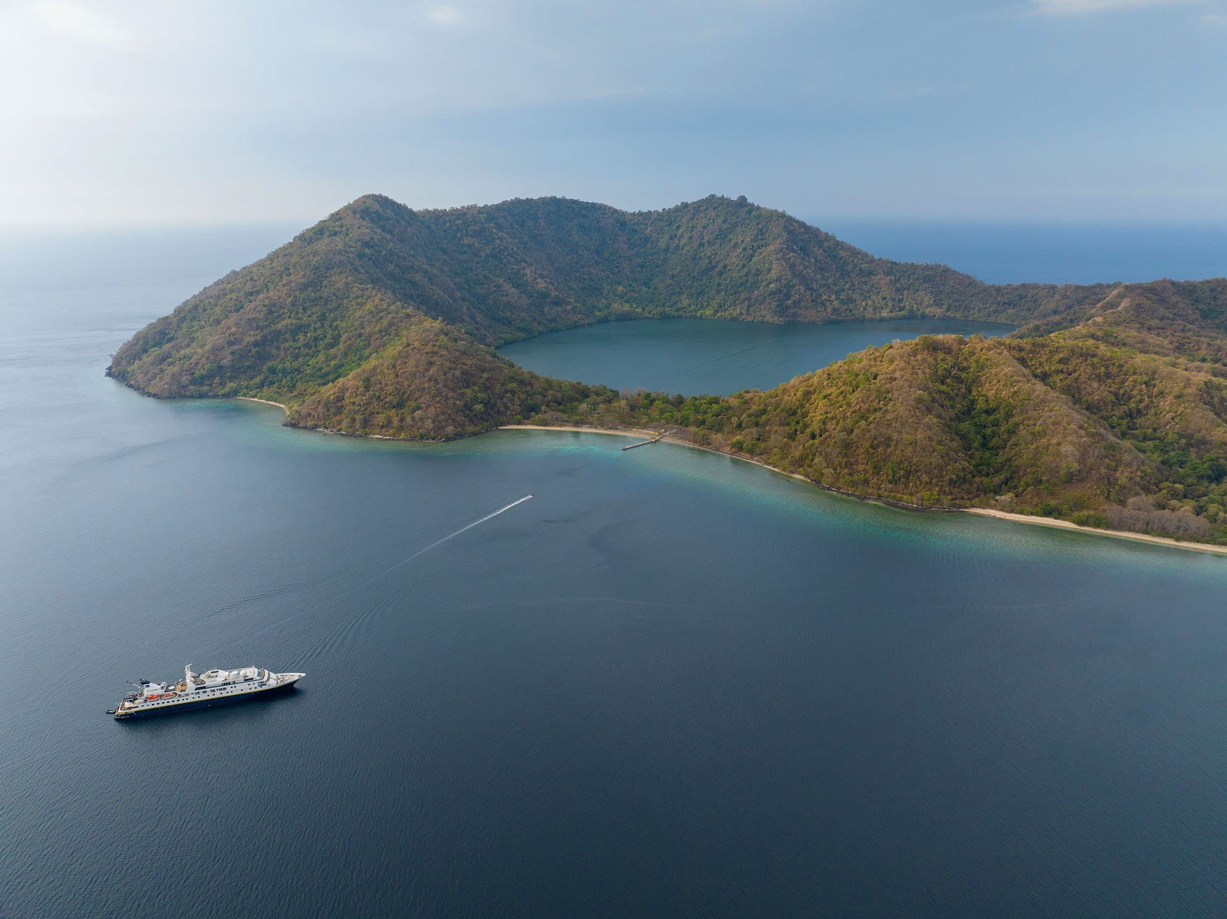 aerial view of national geographic orion parked off the coast of an Indonesian island