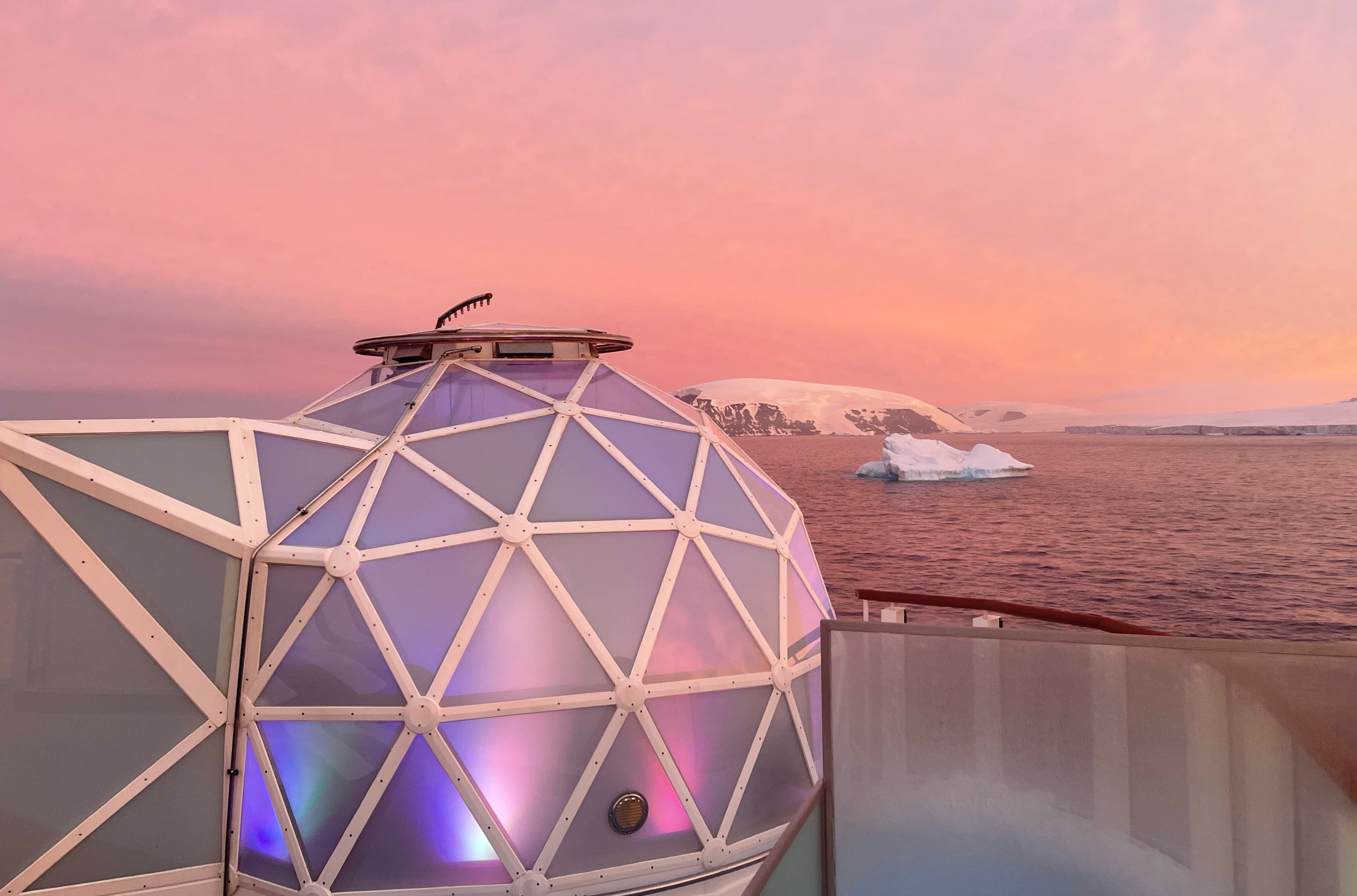 Geodesic glass igloo overlooks Antarctic landscape