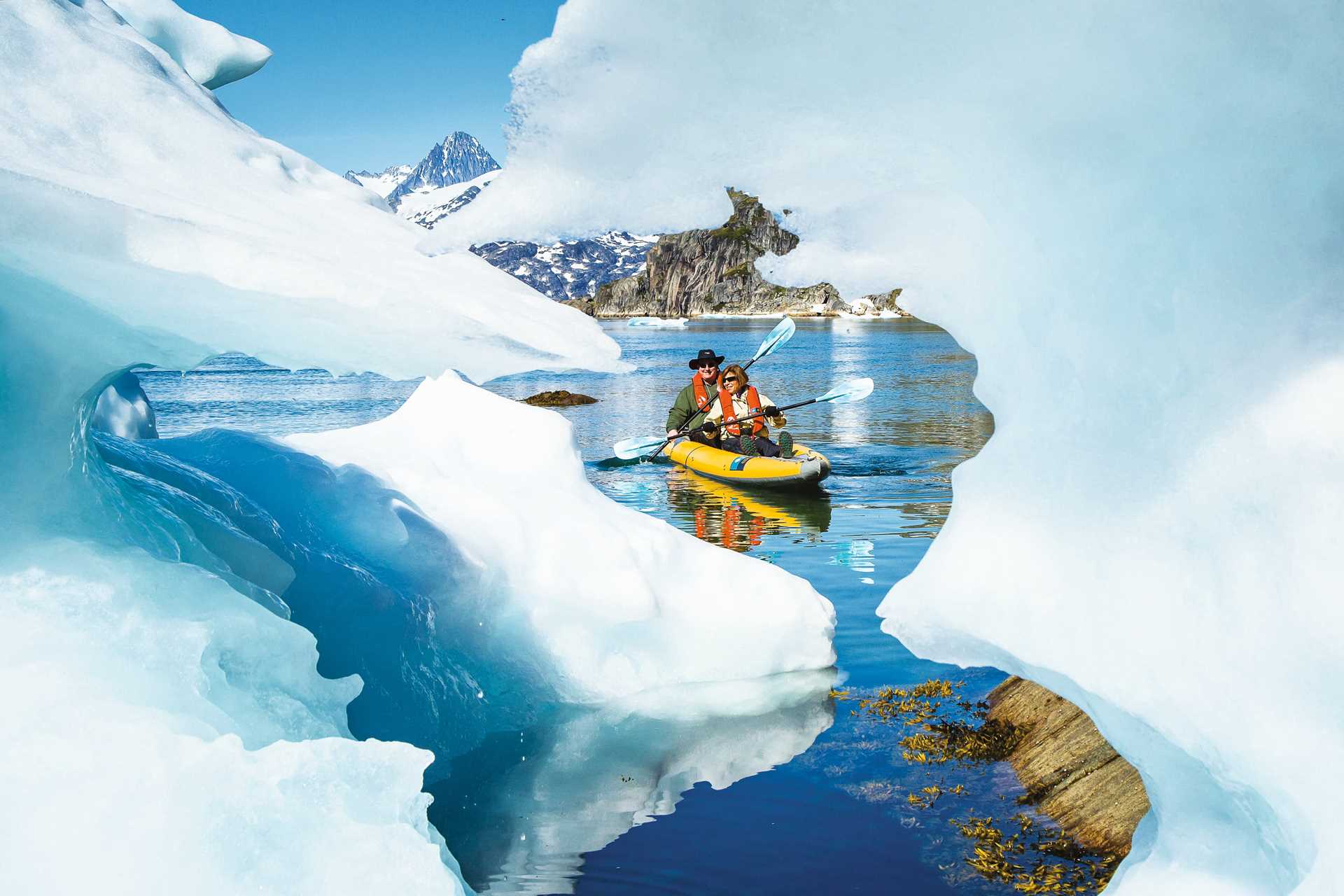 Kayakers explore icebergs in Greenland