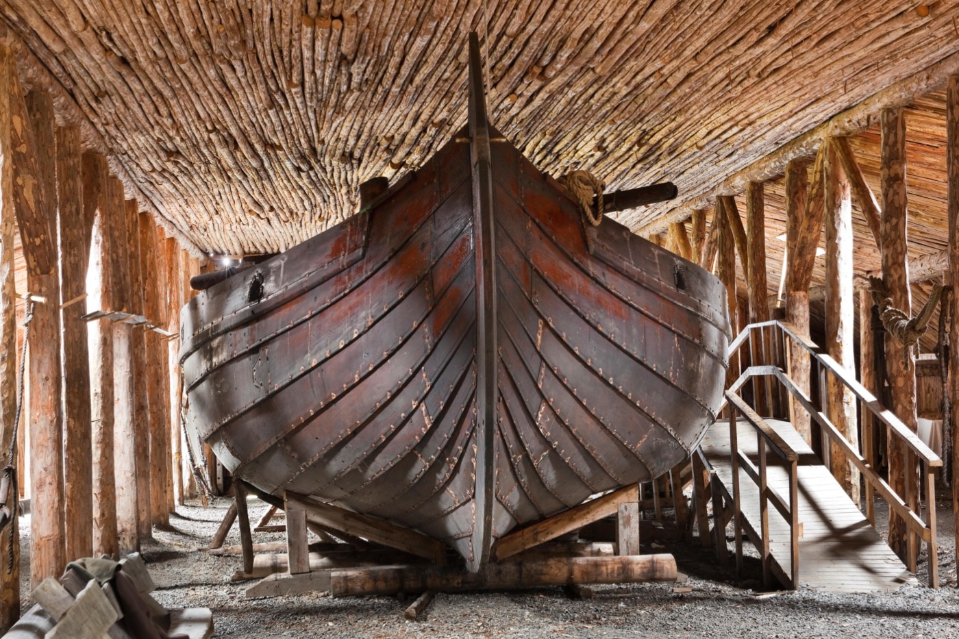 An imposing view of a viking ship's stern. The ships's layered wooden construction resembles an armadillo's shell