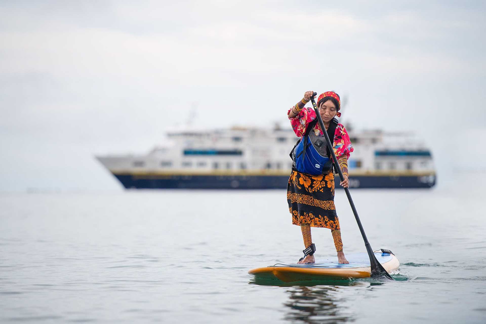 Guna woman standing on a paddleboard