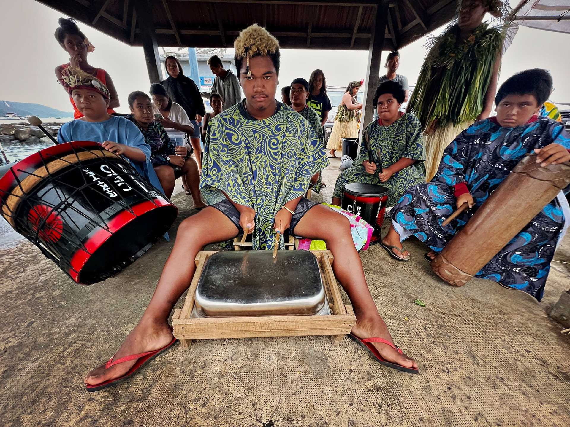 teenaged boy playing a drum