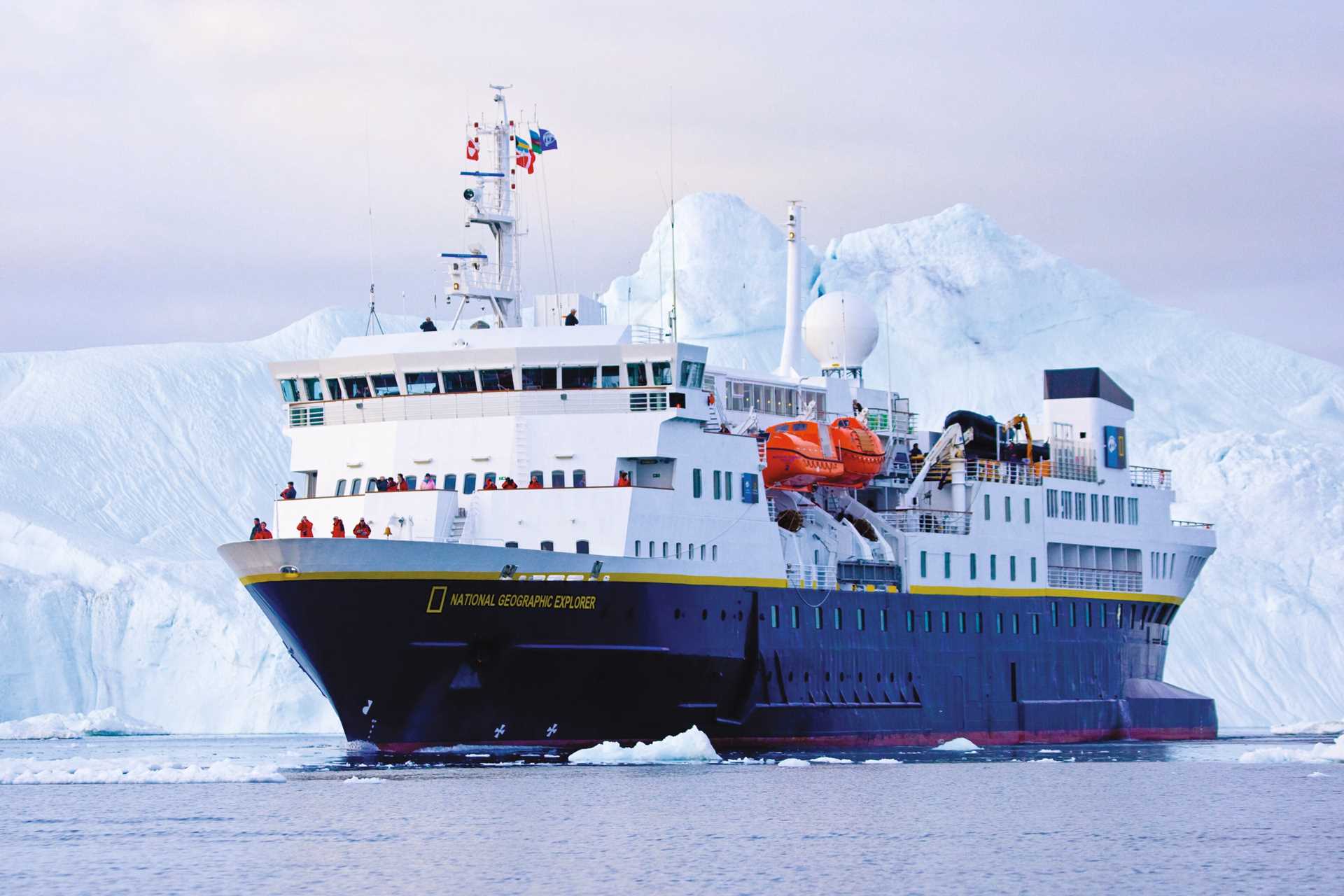 National Geographic Explorer anchored in front of an iceberg in Iluissat, Greenland