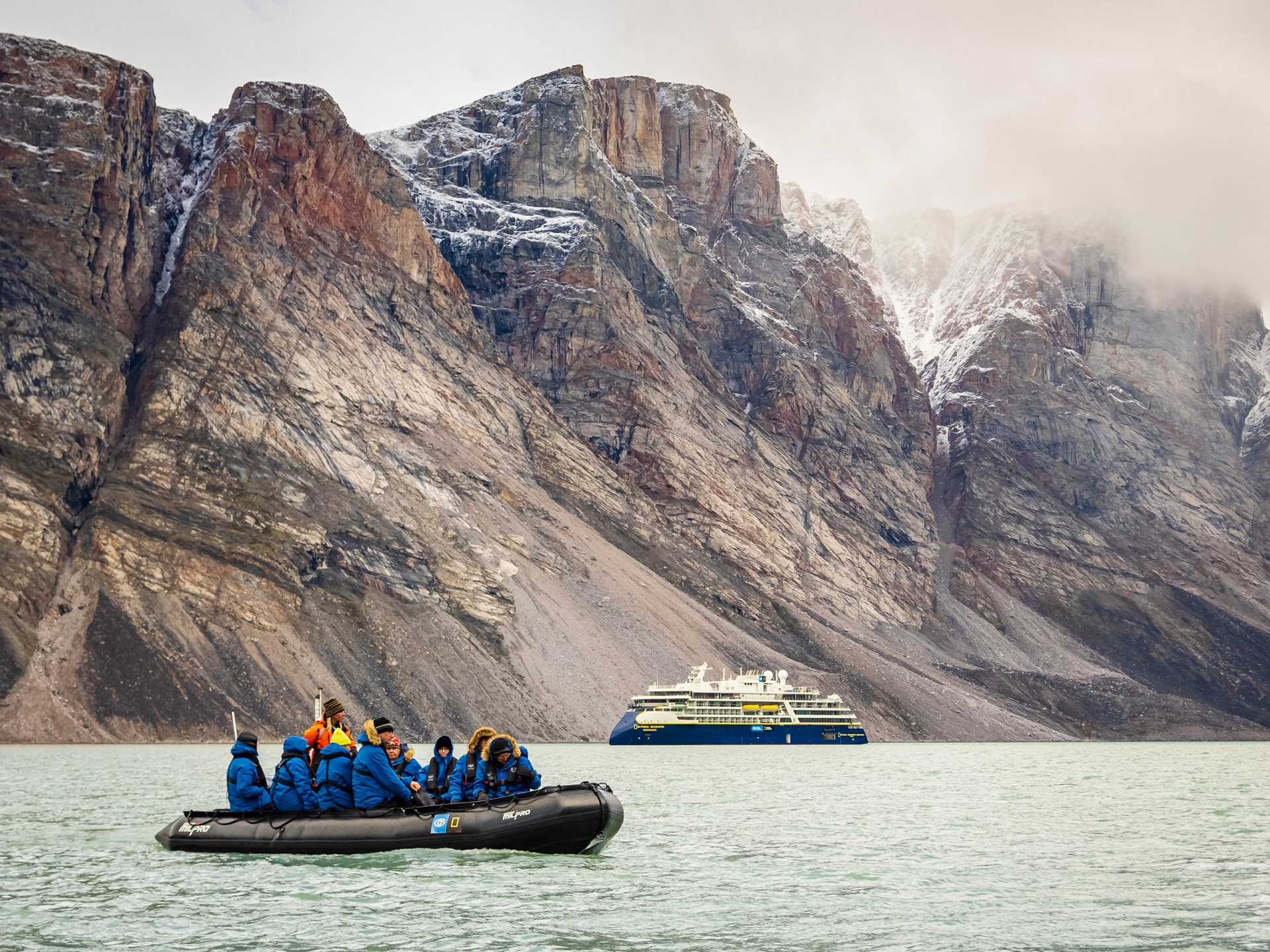 Travelers in Zodiac with National Geographic Resolution in background, Buchan Gulf, Canada