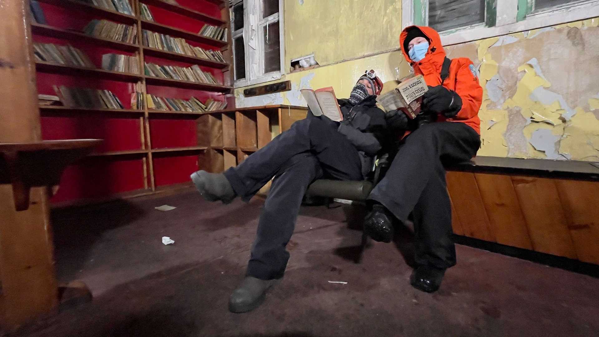 people reading books in abandoned library