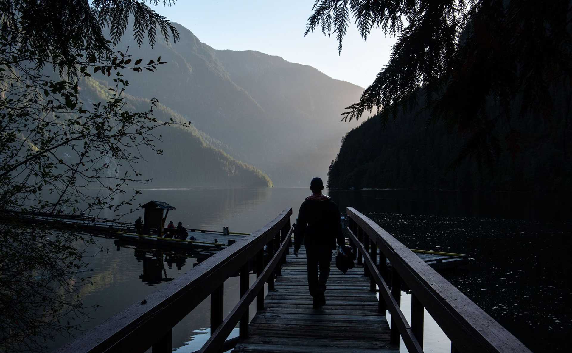 silhouetted figure on a dock