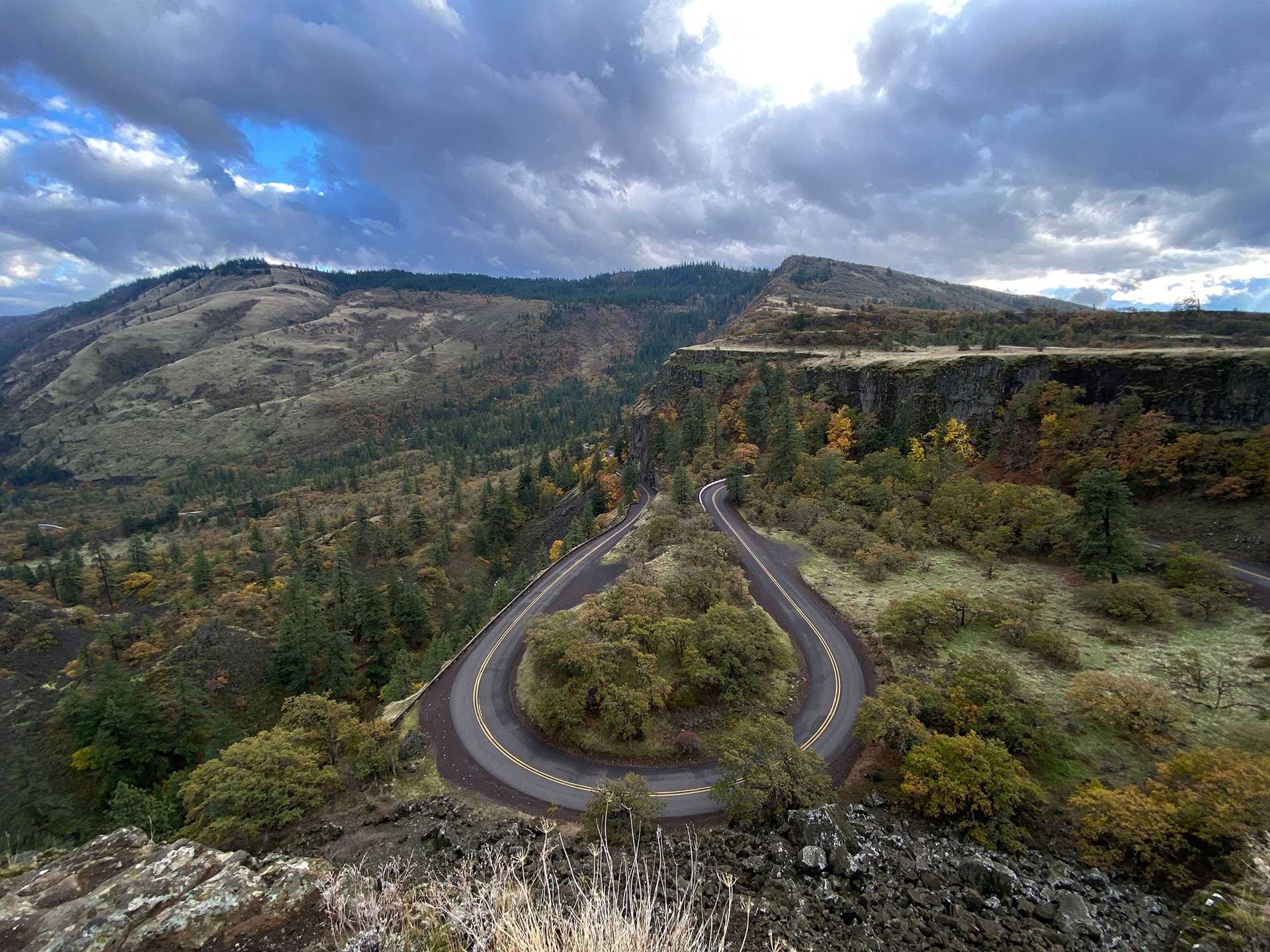 a view of the mountains at Rowena Crest, with a hairpin highway curve visible in the foreground