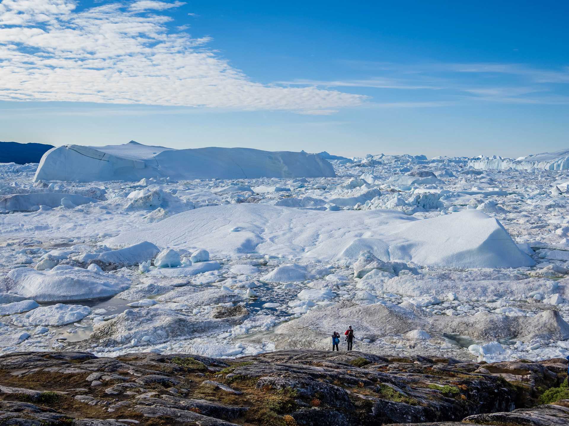 Hikers in front of the Ilulissat Icefjord, Greenland
