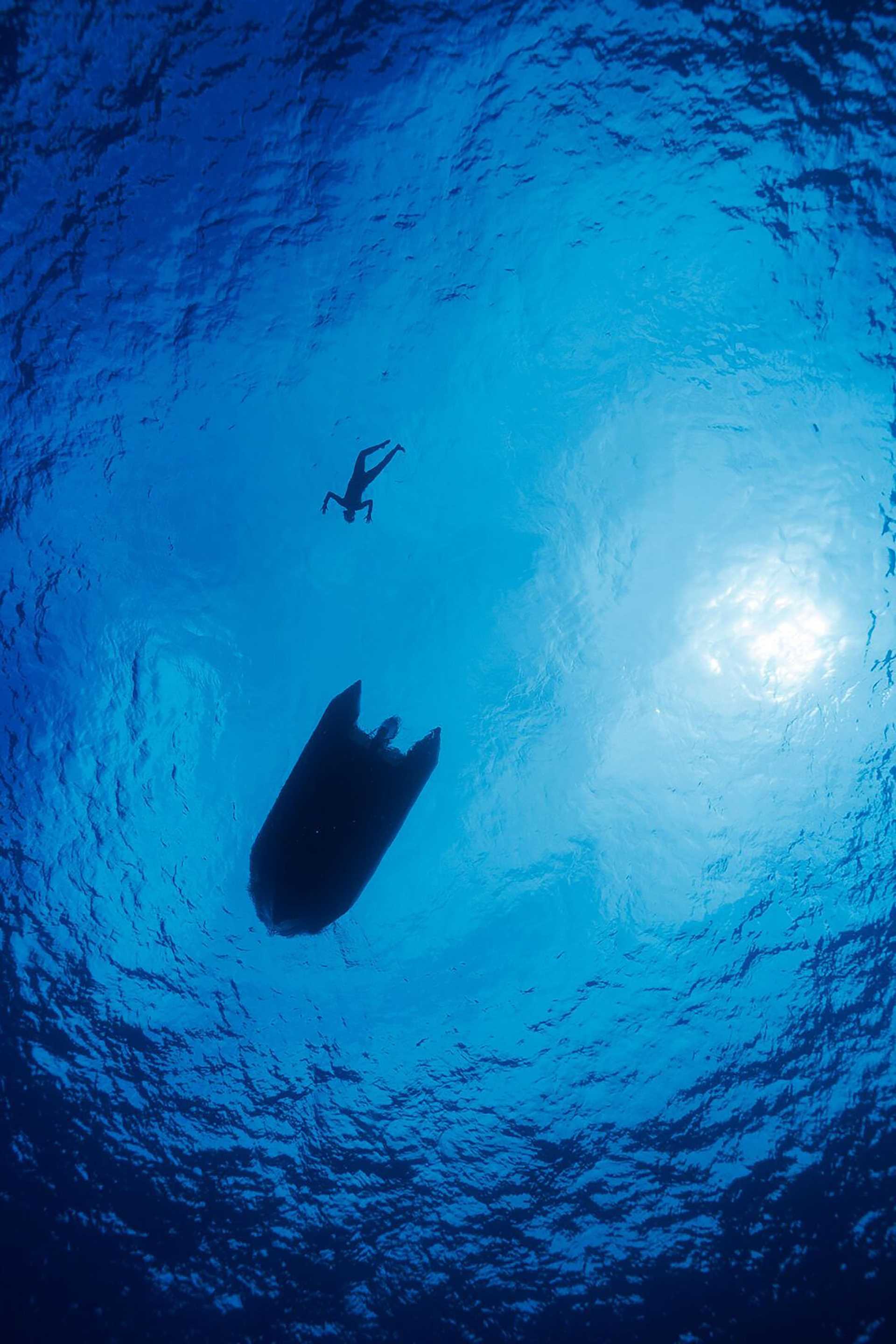 photo of a swimmer floating in blue water