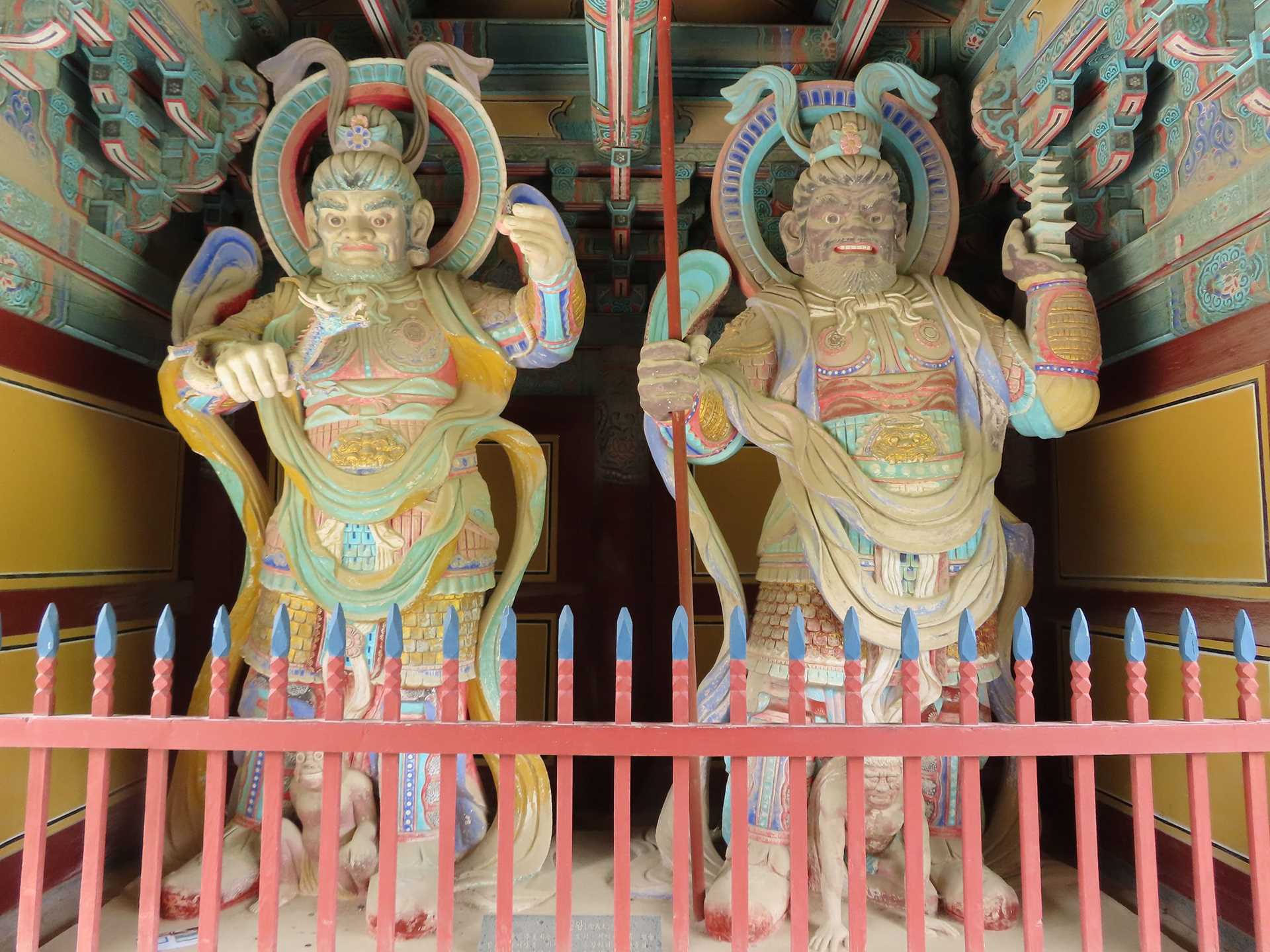 two colorful buddhist statues
