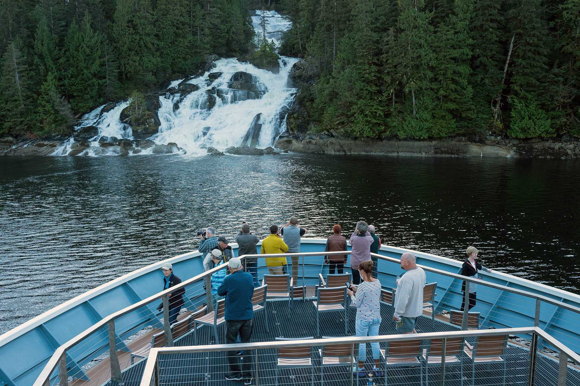 bow of national geographic venture with waterfall in background